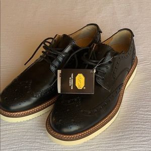 Black leather wing tip shoes. High quality!! New